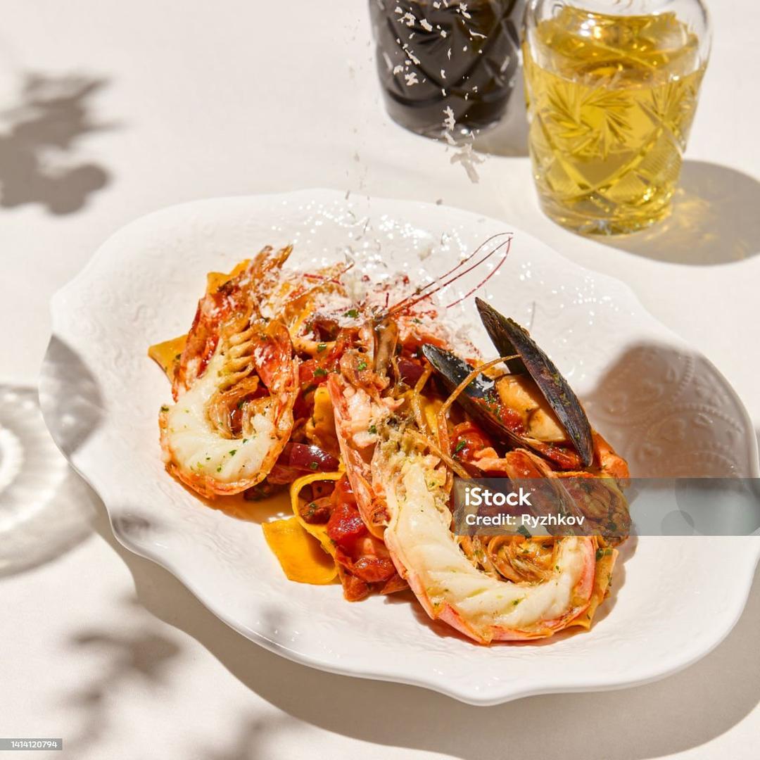 Pappardelle pasta with shrimp and mussels in tomato sauce